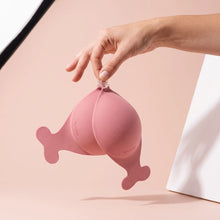 The Statement Bra held up by its clasp to show the size of the cups