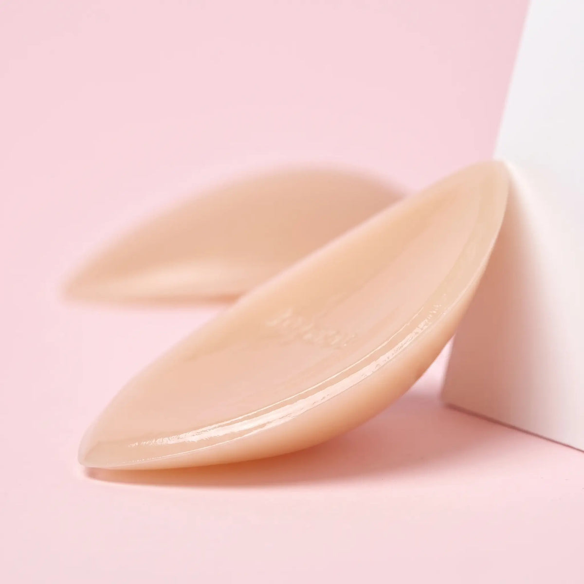 Close-up of The Sculpt Lite insert showing its thin edge and glossy adhesive face