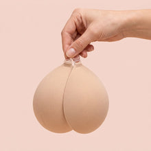 The Sticky Bra held up by its clasp to show the size of the cups