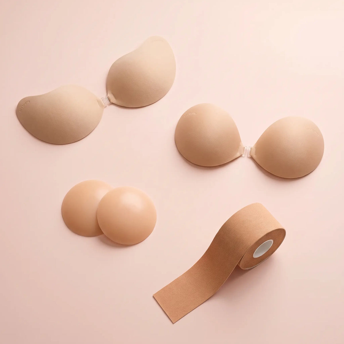 The Sticky Bra Bundle flat lay - the Invisible Bra, the Sticky Bra, round covers and body tape
