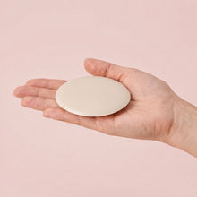 The Sculpt Round cover in Porcelain on an open hand to show its true size