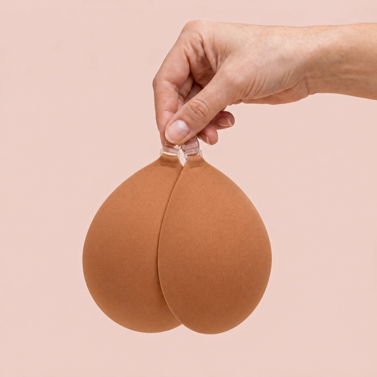 The Sticky Bra in Caramel held up by its clasp to show the size of the cups