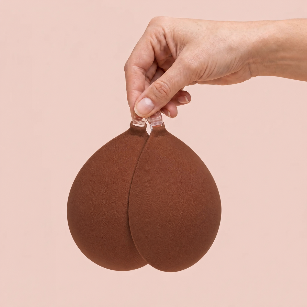 The Sticky Bra in Cocoa held up by its clasp to show the size of the cups