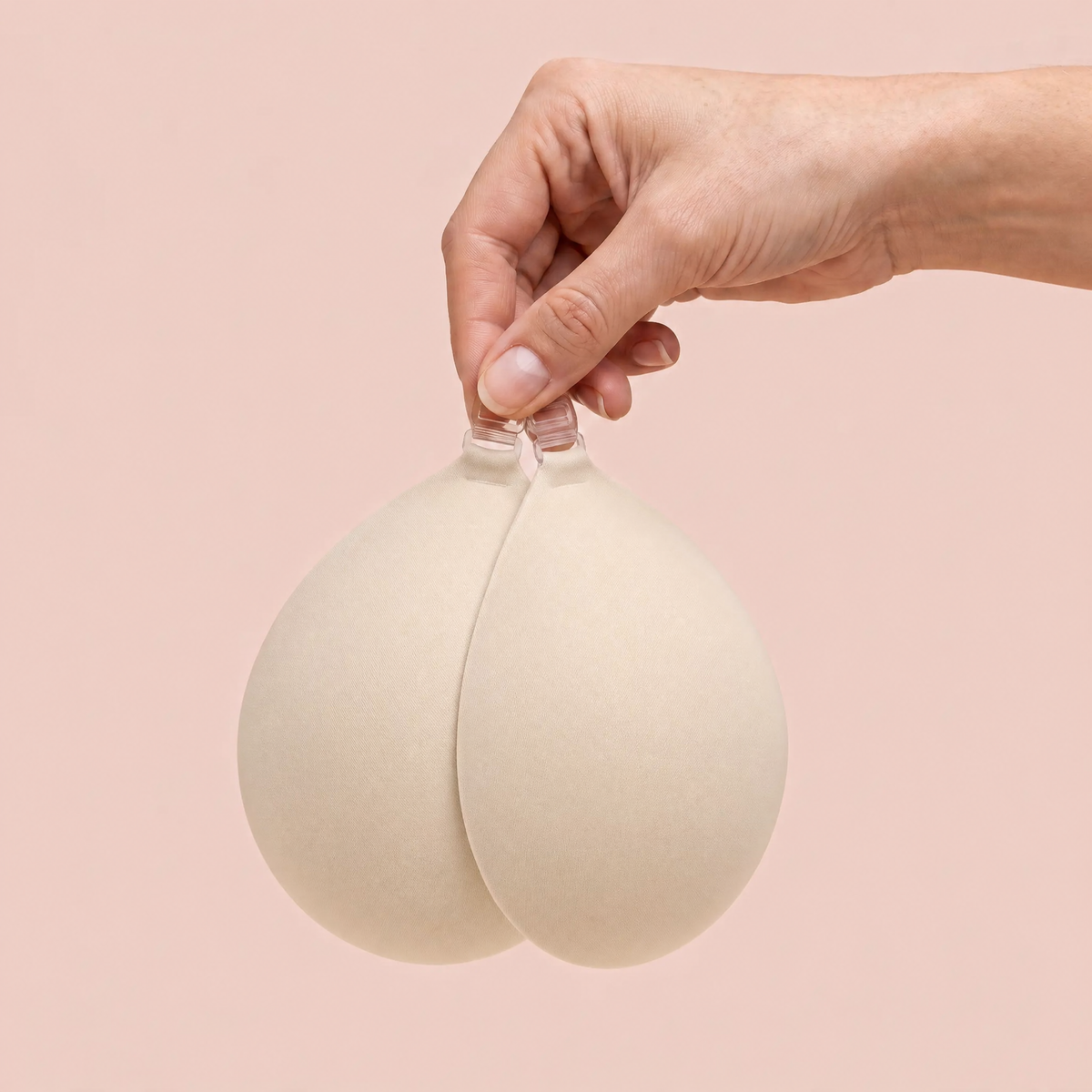 The Sticky Bra in Porcelain held up by its clasp to show the size of the cups