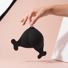 The Statement Bra in Onyx held up by its clasp to show the size of the cups