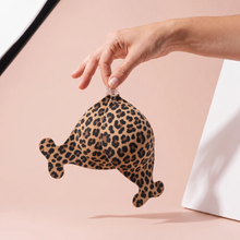 The Statement Bra in Leopard held up by its clasp to show the size of the cups
