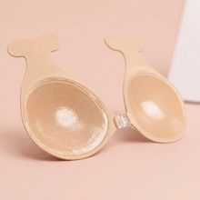 Inside of The Statement Bra cup in Nude showing the adhesive face and the clear front clasp