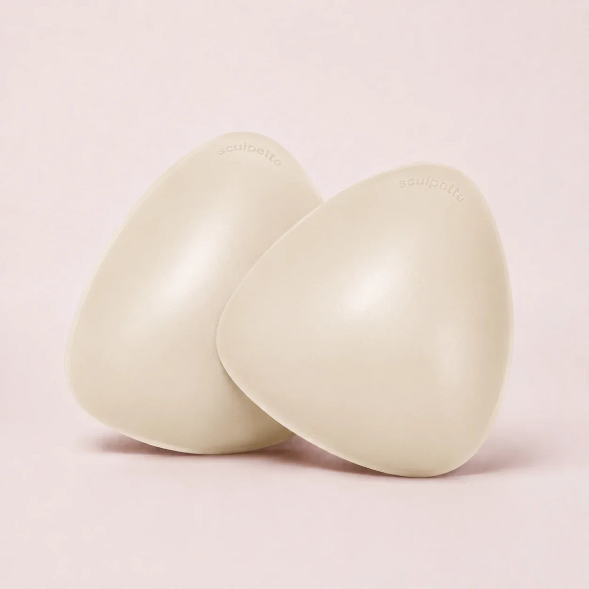 A pair of The Sculpt adhesive bra inserts in Porcelain standing side by side